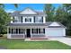 Charming two-story home with a welcoming front porch, black shutters, and a well-maintained lawn at 145 Tara Way, Covington, GA 30016
