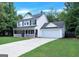 Attractive two-story home featuring an attached garage, driveway, and a neatly manicured lawn at 145 Tara Way, Covington, GA 30016
