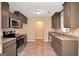 Functional kitchen featuring granite countertops, stainless steel appliances, and tiled flooring at 145 Tara Way, Covington, GA 30016