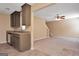 Open-concept living room featuring a view from the kitchen, carpeted floor, and a ceiling fan at 145 Tara Way, Covington, GA 30016