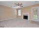 An open living area with fireplace and access to the backyard through the glass door at 145 Tara Way, Covington, GA 30016