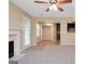 Open concept living area with a fireplace, and views into the dining area and kitchen at 145 Tara Way, Covington, GA 30016