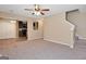 Open concept living area that features a carpeted floor and stairs to the second floor at 145 Tara Way, Covington, GA 30016