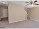 Spacious carpeted living room featuring a ceiling fan and a stairway to the second floor at 145 Tara Way, Covington, GA 30016