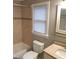 Bathroom with a shower and bathtub, a toilet, a window and a mirror over the sink at 32 Highland Ne Dr, Atlanta, GA 30305