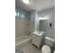 Bright bathroom features a shower/tub combo, black and white floors, and a vanity at 32 Highland Ne Dr, Atlanta, GA 30305
