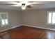 Spacious bedroom featuring hardwood floors, a ceiling fan, and large windows at 32 Highland Ne Dr, Atlanta, GA 30305