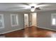 Bedroom showcasing hardwood floors, ceiling fan and multiple windows at 32 Highland Ne Dr, Atlanta, GA 30305