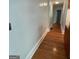 Hallway features smooth walls, white trim, and gleaming hardwood flooring at 32 Highland Ne Dr, Atlanta, GA 30305
