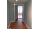 Hallway with hardwood floors and an open doorway to a sunlit room at 32 Highland Ne Dr, Atlanta, GA 30305