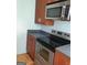 Kitchen featuring modern stainless steel appliances and wood cabinets at 32 Highland Ne Dr, Atlanta, GA 30305