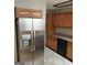 Modern kitchen with stainless steel refrigerator, wood cabinets and black dishwasher at 32 Highland Ne Dr, Atlanta, GA 30305