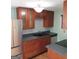Kitchen featuring dark countertops and wood cabinets, stainless steel refrigerator at 32 Highland Ne Dr, Atlanta, GA 30305