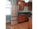 Kitchen featuring a stainless steel refrigerator, dark countertops, and wood cabinets at 32 Highland Ne Dr, Atlanta, GA 30305
