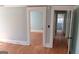 Bright living room with hardwood floors and white trim, leading to other rooms at 32 Highland Ne Dr, Atlanta, GA 30305