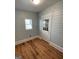Well-lit room with wood-look flooring, shiplap walls, and a window at 32 Highland Ne Dr, Atlanta, GA 30305