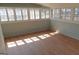 Sunroom with wood floors, beadboard paneling, and lots of windows for natural light at 32 Highland Ne Dr, Atlanta, GA 30305