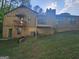 Back exterior of home with second story deck and walk out basement at 3244 Harbor Woods Rd, Decatur, GA 30034