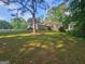 Front yard of home with mature trees and a large grassy area at 3244 Harbor Woods Rd, Decatur, GA 30034