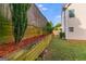 Landscaped backyard featuring a multi-tiered retaining wall and lush greenery at 507 Rippling Dr, Temple, GA 30179