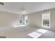 Spacious bedroom featuring multiple windows, a ceiling fan, and neutral carpeting, offering a bright and airy feel at 507 Rippling Dr, Temple, GA 30179