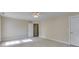 Bedroom with neutral carpeting, a ceiling fan, and access to another room, creating a comfortable and inviting space at 507 Rippling Dr, Temple, GA 30179