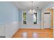 Sunny dining area with hardwood floors, wainscoting, and views from two bright windows at 507 Rippling Dr, Temple, GA 30179