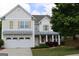 Charming two-story home with neutral siding, attached garage and well-manicured landscaping at 507 Rippling Dr, Temple, GA 30179