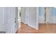 Hallway with hardwood flooring offering seamless transition between rooms of the home at 507 Rippling Dr, Temple, GA 30179