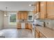 Well-lit kitchen with wooden cabinets, tile backsplash, and modern appliances at 507 Rippling Dr, Temple, GA 30179
