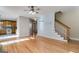 Bright open living room area featuring hardwood floors connecting to the kitchen and stairway at 507 Rippling Dr, Temple, GA 30179