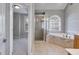 Bathroom featuring a separate tiled shower and soaking tub, along with natural light from a window at 507 Rippling Dr, Temple, GA 30179