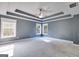 Spacious main bedroom featuring a trey ceiling, large windows and neutral carpeting at 507 Rippling Dr, Temple, GA 30179