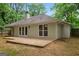 Backyard view of the house featuring a concrete patio and surrounding greenery and trees at 1000 Arbor Forest Sw Way # 1000, Marietta, GA 30064
