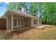 View of a house's backyard featuring a patio area and green space, surrounded by trees at 1000 Arbor Forest Sw Way # 1000, Marietta, GA 30064