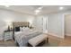 Well-lit bedroom with a tufted headboard, stylish bedding, a ceiling fan, and hardwood floors for a comfortable living space at 1000 Arbor Forest Sw Way # 1000, Marietta, GA 30064