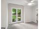 A bright, carpeted bedroom with a large window that allows natural light to fill the room at 1000 Arbor Forest Sw Way # 1000, Marietta, GA 30064