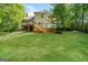 Exterior backyard featuring a deck and steps leading to a green, grassy yard at 205 Huntwood Ct, Ellenwood, GA 30294
