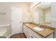 Bathroom features a granite countertop with double sinks and white cabinets below at 205 Huntwood Ct, Ellenwood, GA 30294