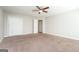 Bedroom featuring neutral carpeting, a ceiling fan, and a closet for storage at 205 Huntwood Ct, Ellenwood, GA 30294