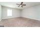 Spacious bedroom with neutral carpet, ceiling fan, and natural light from the window at 205 Huntwood Ct, Ellenwood, GA 30294