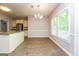 Dining area featuring hardwood floors, natural light, view into the kitchen and backyard at 205 Huntwood Ct, Ellenwood, GA 30294