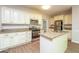 Bright kitchen with stainless steel appliances, granite countertops, and ample cabinet space at 205 Huntwood Ct, Ellenwood, GA 30294