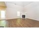 Spacious living room featuring vaulted ceiling, wood floors, a fireplace and ample natural light at 205 Huntwood Ct, Ellenwood, GA 30294