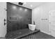 Elegant bathroom with a soaking tub, black herringbone tile, and sleek, contemporary shower fixtures at 378 Grant Park Se Pl, Atlanta, GA 30315