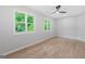 Bright bedroom with hardwood floors, many windows, and a modern ceiling fan at 378 Grant Park Se Pl, Atlanta, GA 30315