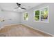 Light bedroom featuring hardwood floors, two windows, and a modern ceiling fan at 378 Grant Park Se Pl, Atlanta, GA 30315