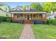 Charming home boasts a covered front porch with wooden railings and a brick walkway leading to the entrance at 378 Grant Park Se Pl, Atlanta, GA 30315