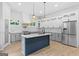 Bright modern kitchen featuring stainless steel appliances, white cabinets, and a large blue island at 378 Grant Park Se Pl, Atlanta, GA 30315