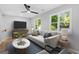 Bright living room with stylish furniture, large windows, and modern ceiling fan at 378 Grant Park Se Pl, Atlanta, GA 30315